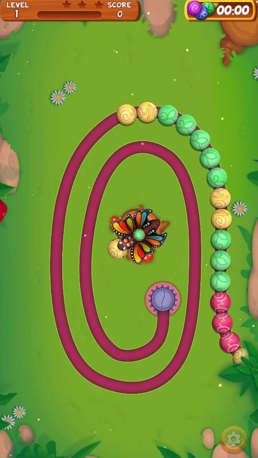 Marble Puzzle Blast 1 Game with a butterfly and flowers on a green background, with a winding path.