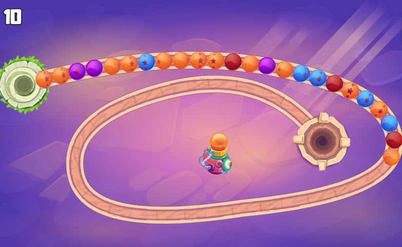 Zuma Boom 1 Game scene with a rocket and colorful balls on a space track.