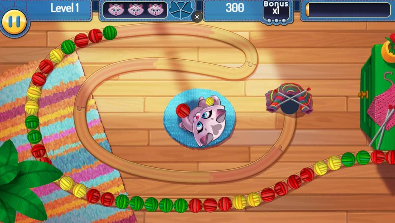 Zuma Hit or Knit 1 Game screen with a kitten playing on a wooden floor — bright colors and game elements.